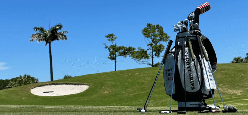 Goat Grips Tour Staff bag surrounded by putters with the best performance grips on the market